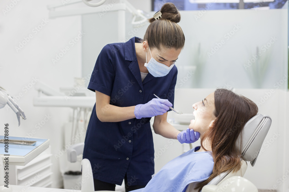 At the dentist. Female dentist in action. At the dentist. Female dentist in action.