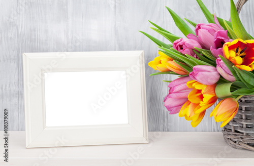 Fototapeta Naklejka Na Ścianę i Meble -  Fresh colorful tulips bouquet and photo frame