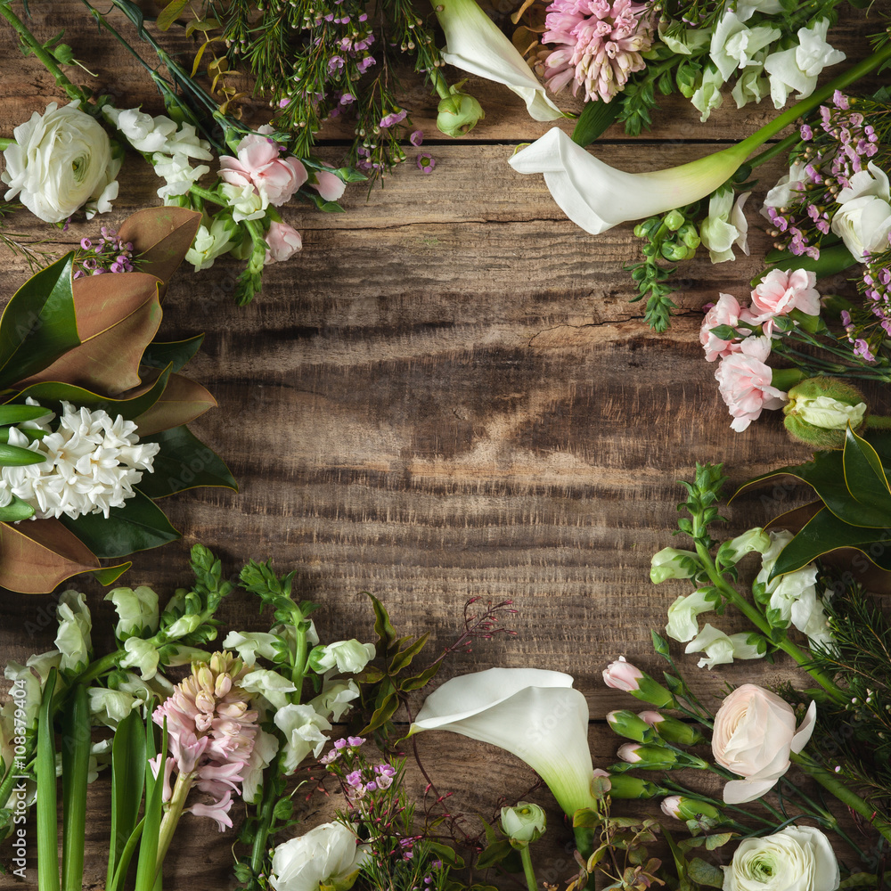 Frame from flowers on wooden background Frame from flowers on wooden background