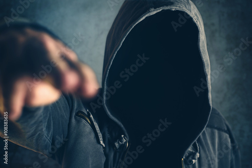Photos Hooded criminal gesturing gun shooting with fingers