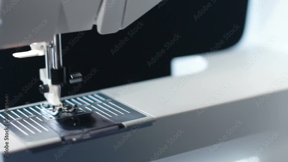 Sewing needle in slow motion. Panning on sewing needle of modern sewing machine. Closeup. Work