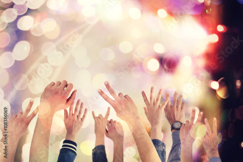 People raising up hands at concert