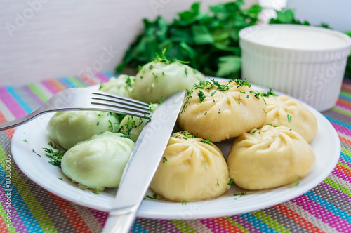 Traditional national Caucasian dish "Khinkali" with sour cream