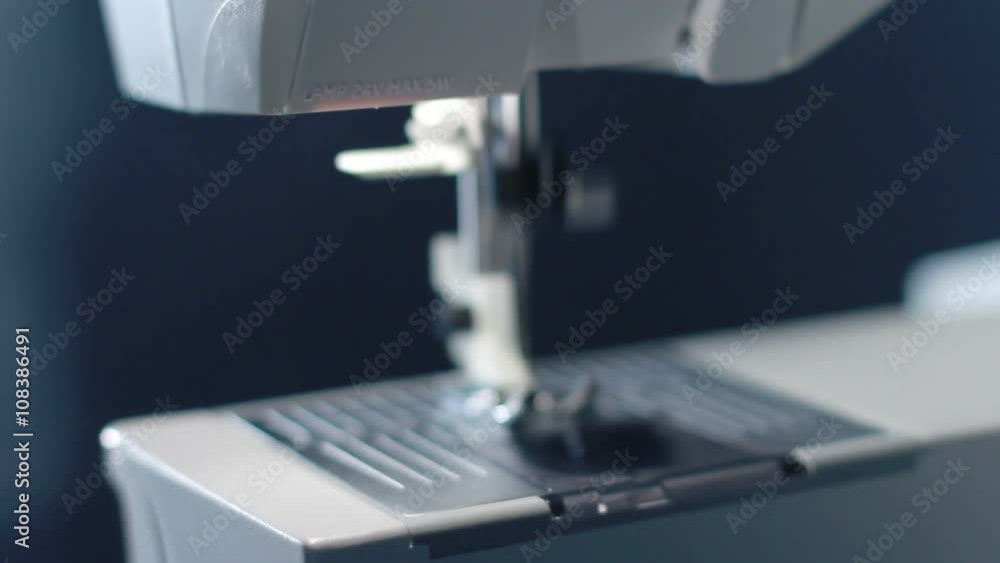 Sewing needle of modern sewing machine. Sewing machine needle work process. Sewing needle