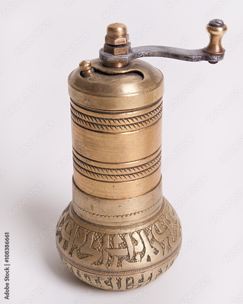 Hand mill for spices on a white background Hand mill for spices on a white background