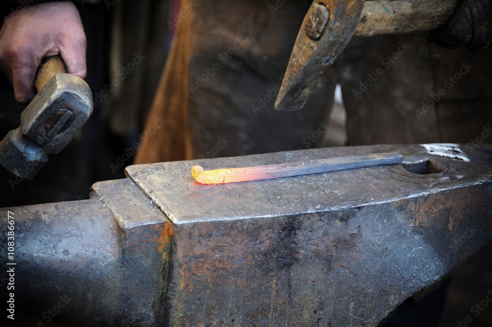Blacksmith forges a horseshoe Blacksmith forges a horseshoe