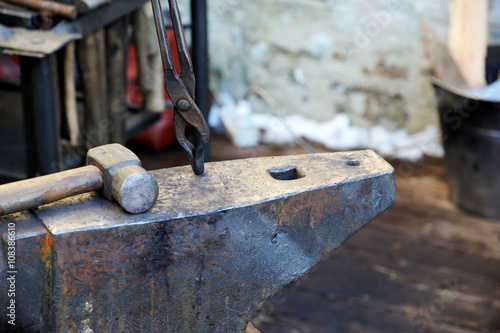 Blacksmith forges a horseshoe