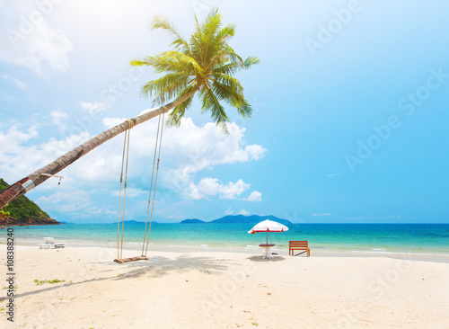 Beautiful tropical island beach with coconut palm trees and swing © Alexander Ozerov