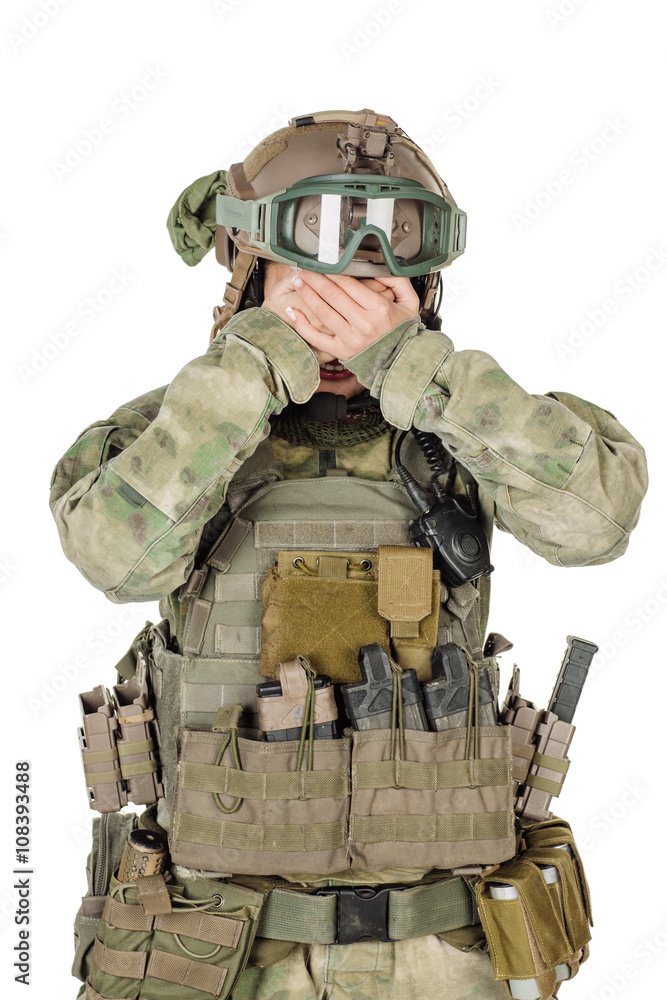 Fototapeta premium soldier or private military contractor closes eyes with her hands. war, army, weapon and people concept. Image on a white background
