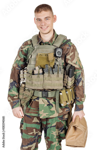 soldier wearing camouflage holding paper bag in his hand .war, army, weapon, technology and people concept. Image on a white background.