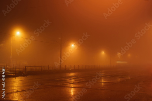 Street lights in foggy misty night,