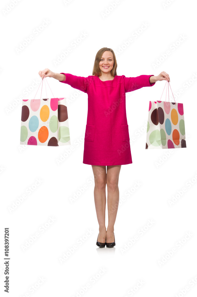 Shopper girl in pink dress holding plastic bags isolated on whit Shopper girl in pink dress holding plastic bags isolated on whit