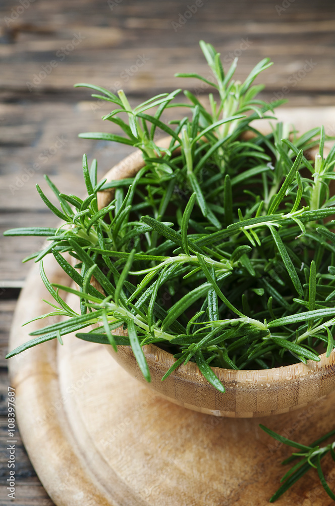 Aromatic fresh rosemary on the wooden table Aromatic fresh rosemary on the wooden table
