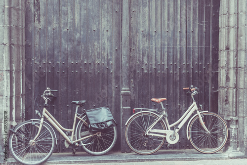 Bicycles leaning against old wooden door