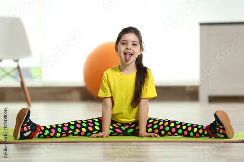Little funny girl sitting i...