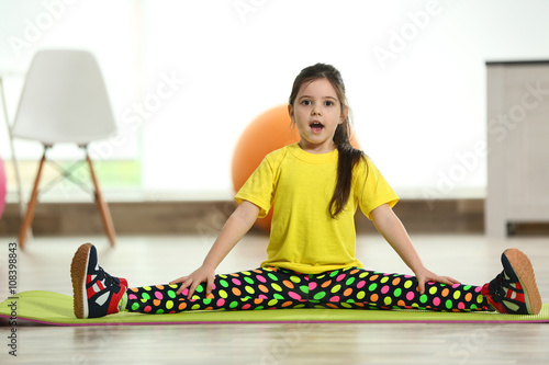 Little cute girl sitting in...