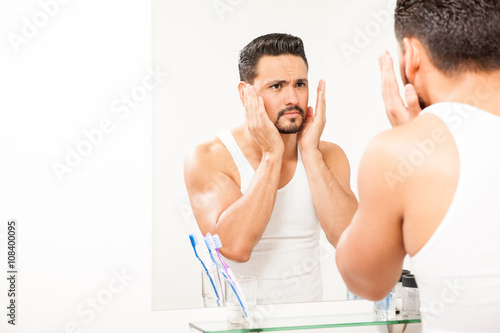 Man putting on some cologne on his face