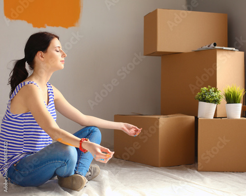 Woman in a new home with cardboard boxes