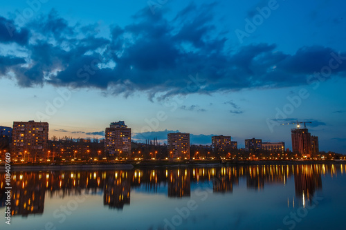 Night city reflection on the river in Donetsk. Ukraine