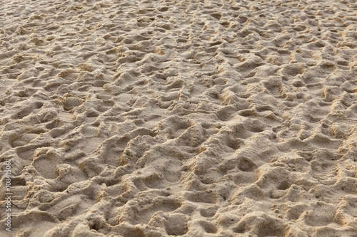 Yellow sand covered with many human footprints