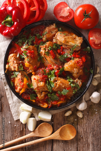 chicken stew with vegetables on a table close-up. vertical top view 
