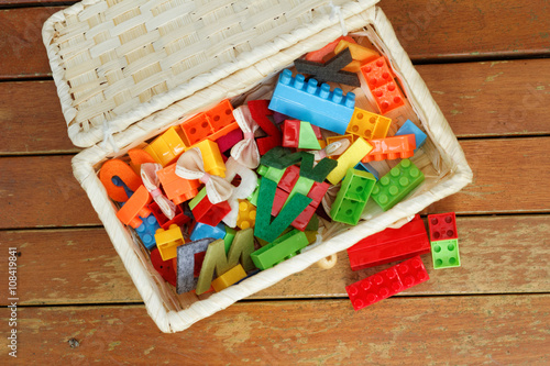 Small box filled with children's small toys for education. View from top