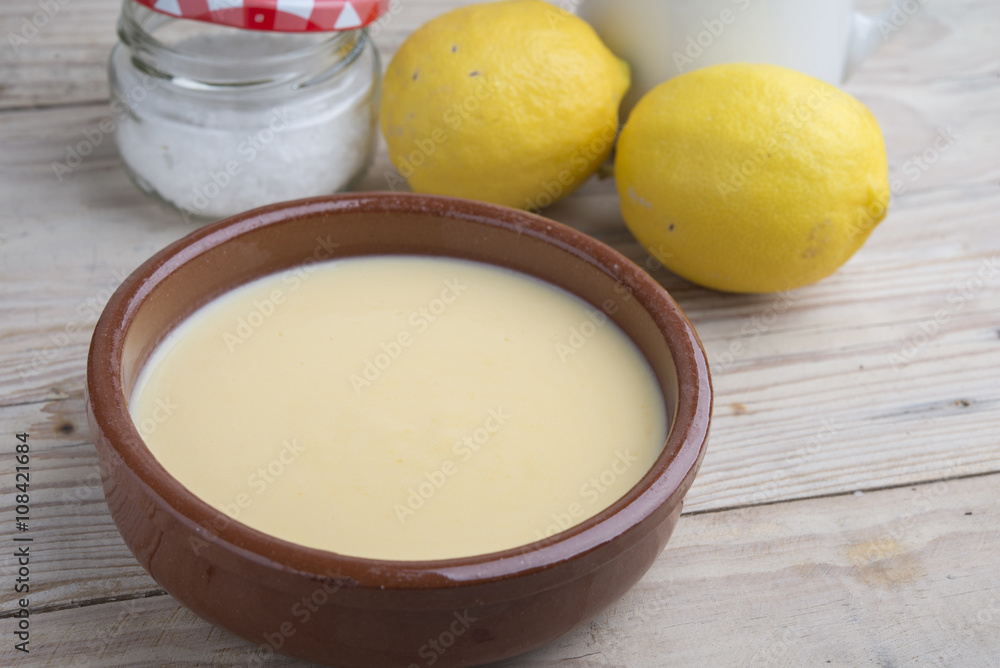 Traditional creme brulee on ceramic dish on wooden table Traditional creme brulee on ceramic dish on wooden table