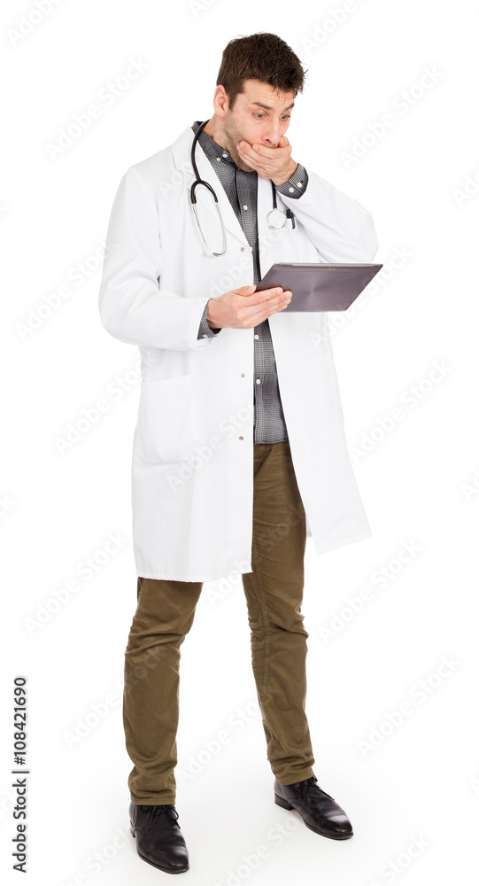 Male Caucasian doctor holding a digital tablet, looking shocked Male Caucasian doctor holding a digital tablet, looking shocked