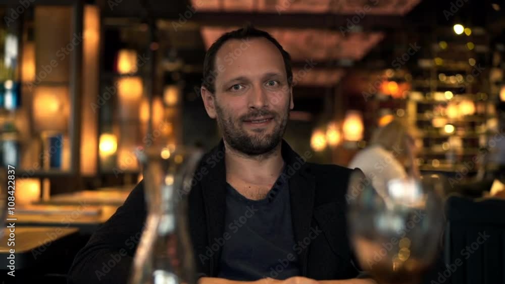 Happy man sitting in cafe at night
Happy man sitting in cafe at night