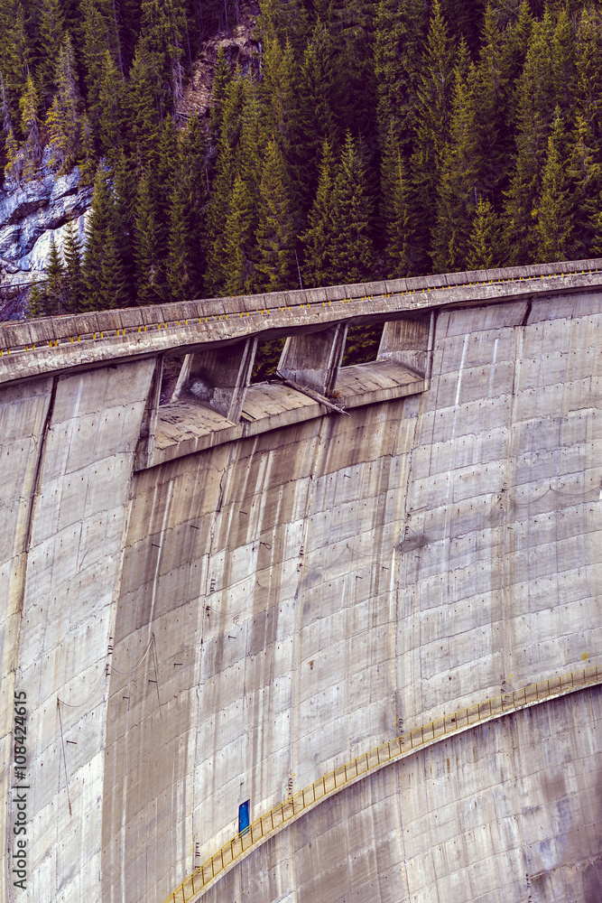 Wide view of a concrete dam in the mountains