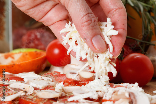 Cooking homemade pizza with...