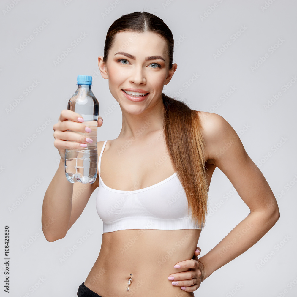 sporty woman over gray background drinking water sporty woman over gray background drinking water