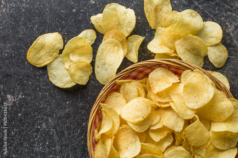 Crispy potato chips in a wicker bowl