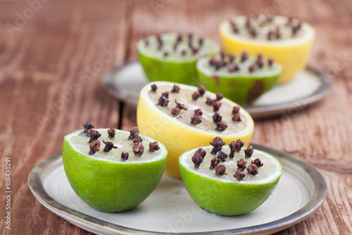 Lemon and limes with cloves, natural insect repellent photo