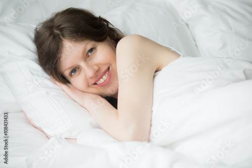 Woman relaxing in the morning in bed