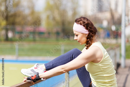 Young sporty woman stretching before jogging © skumer