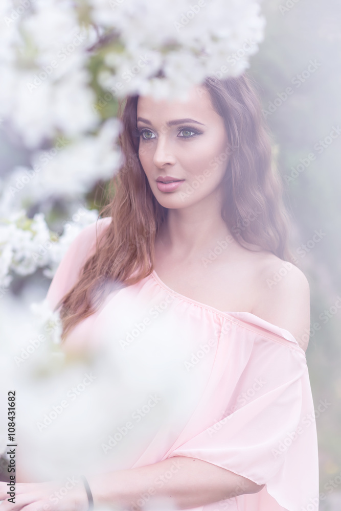 Beautiful woman - near the flowering trees Beautiful woman - near the flowering trees
