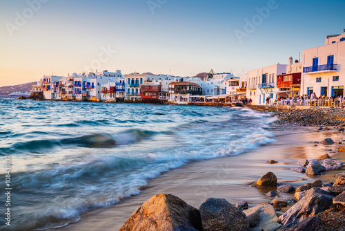 Rolling waves and sunset dining at fmaous Mykonos neighborhood of Little Venice, Mykonos, Greece photo
