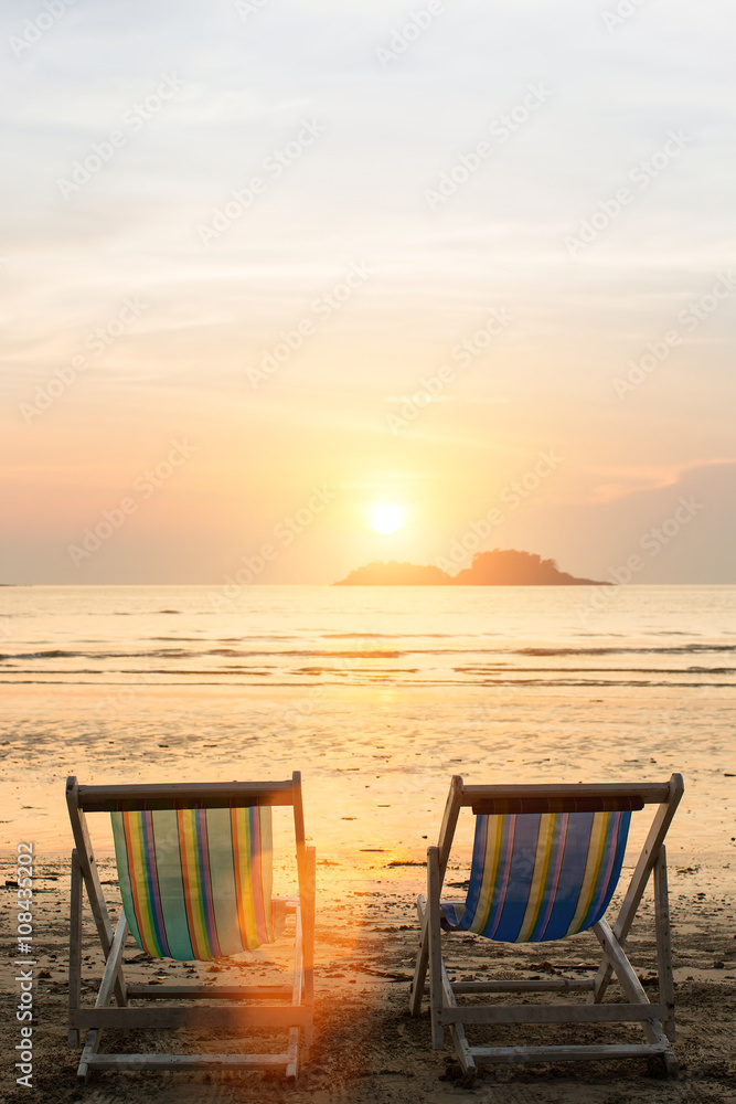 Sun loungers on the beach during sunset.