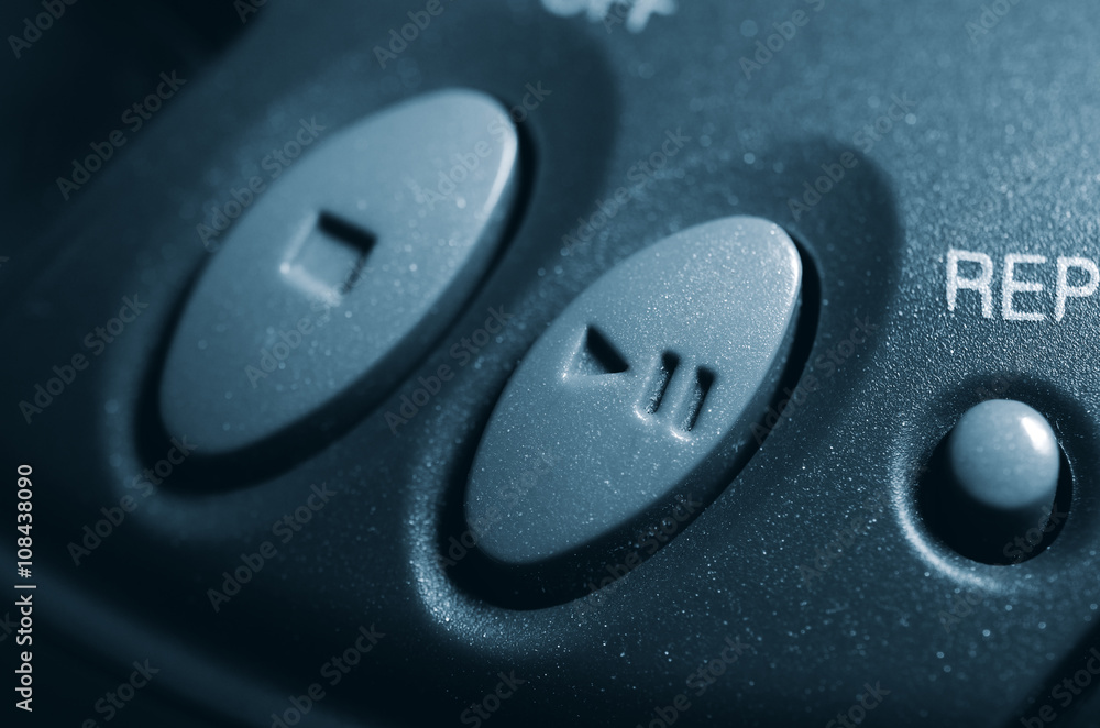 Mechanical play and stop button electronic device. Two buttons together. Concept. Close up view. Vintage photo toning. Mechanical play and stop button electronic device. Two buttons together. Concept. Close up view. Vintage photo toning.