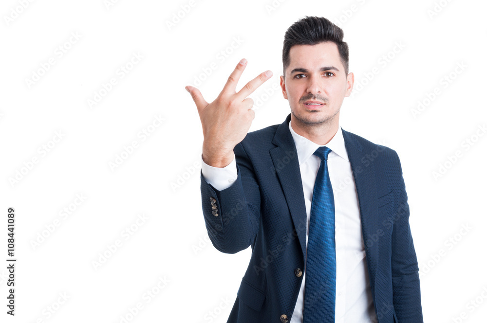 Smiling businessman or sales man showing number three Smiling businessman or sales man showing number three