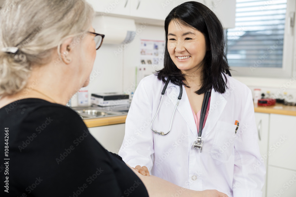 Smiling Doctor Touching Senior Patient's Arm Before Blood Test Smiling Doctor Touching Senior Patient's Arm Before Blood Test