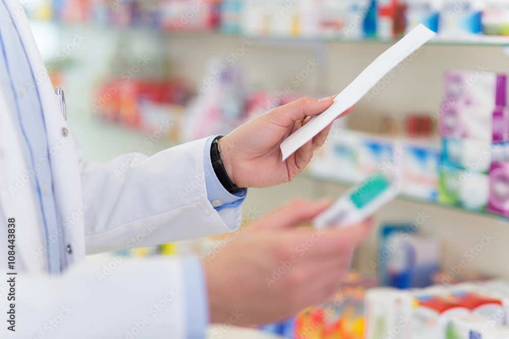 Pharmacist filling prescription in pharmacy