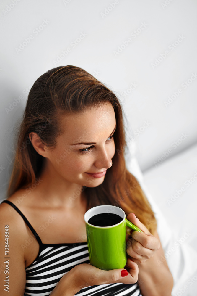 Drink Morning Coffee. Closeup Beautiful Happy Smiling Woman Enjoying Cup Of Coffee In Morning. Model Drinking Hot Beverage. Girl Lying In Bed, Relaxing At Home. Diet Drinks Concept. Healthy Lifestyle Drink Morning Coffee. Closeup Beautiful Happy Smiling Woman Enjoying Cup Of Coffee In Morning. Model Drinking Hot Beverage. Girl Lying In Bed, Relaxing At Home. Diet Drinks Concept. Healthy Lifestyle