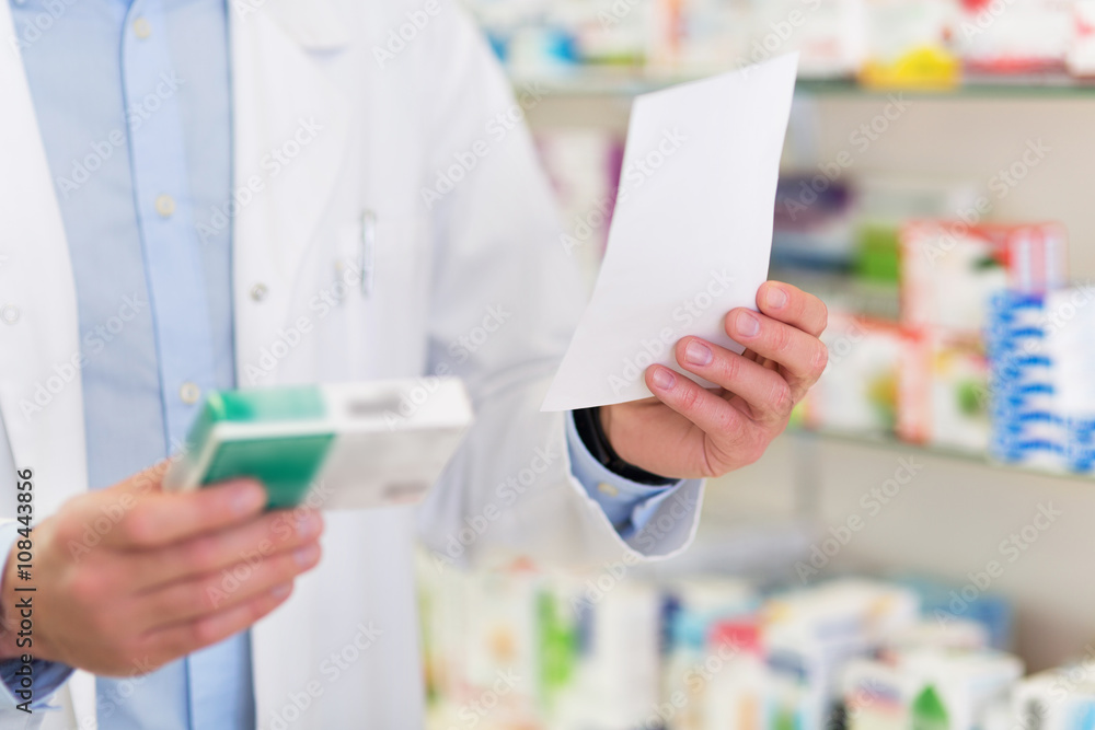 Pharmacist filling prescription in pharmacy - obrazy, fototapety, plakaty 