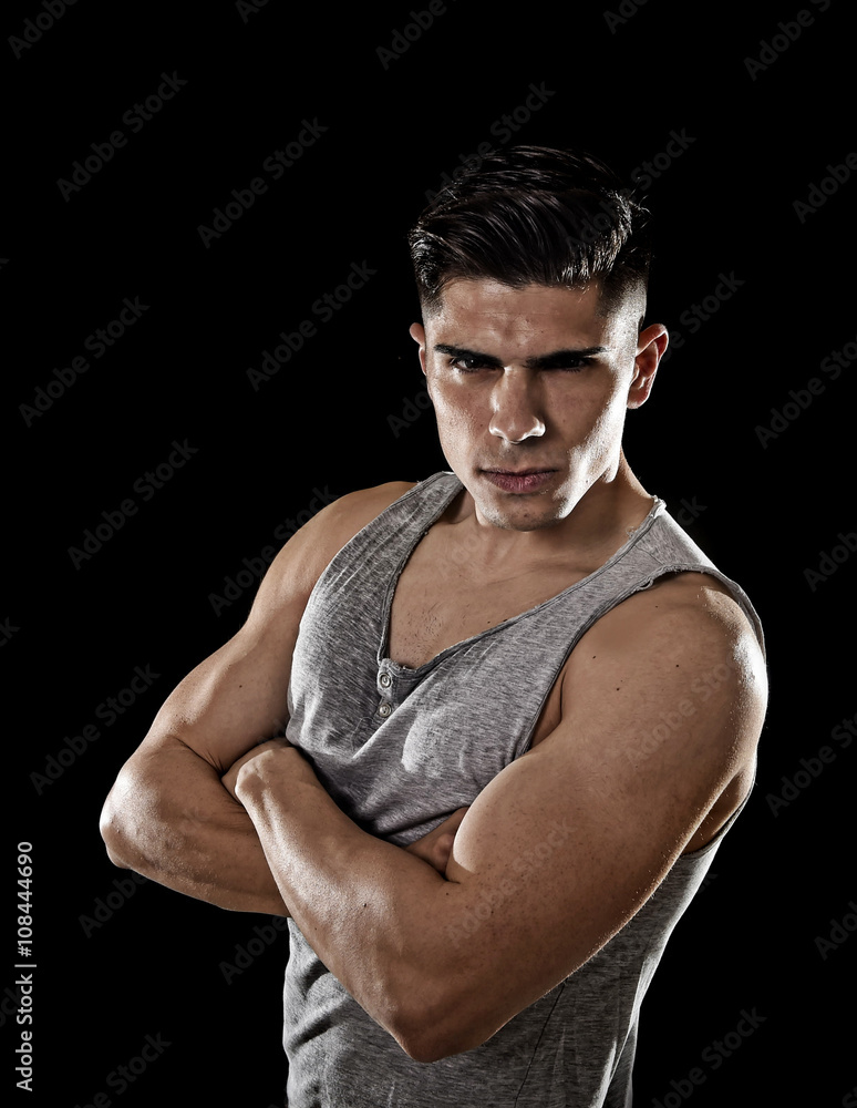 young attractive sport man with big and strong athletic body posing with folded arms young attractive sport man with big and strong athletic body posing with folded arms