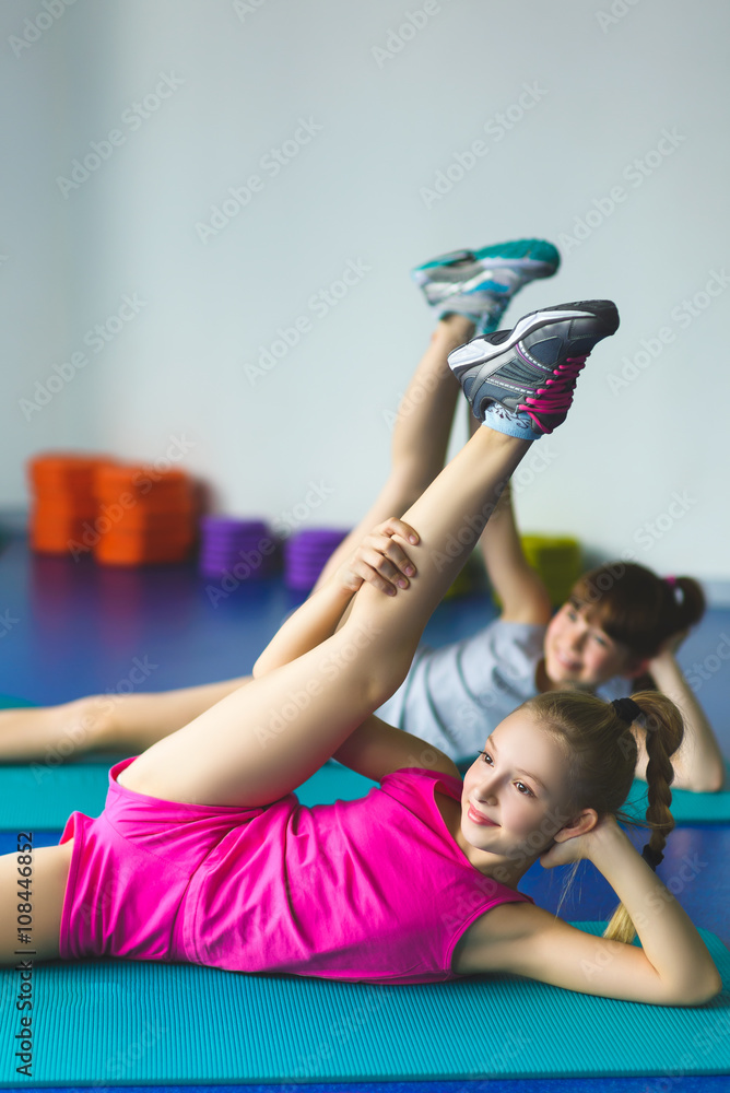 Two girls doing yoga stretching in fitness class Stock Photo
