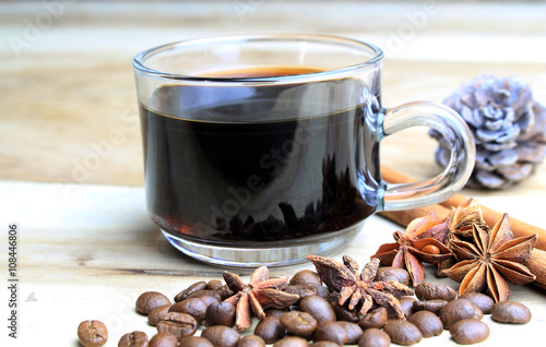 Fototapeta Naklejka Na Ścianę i Meble -  cup of coffie with cinnamon and star anise on wooden background