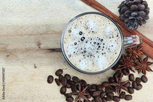 Fototapeta Naklejka Na Ścianę i Meble -  cup of coffie with cinnamon and star anise on wooden background