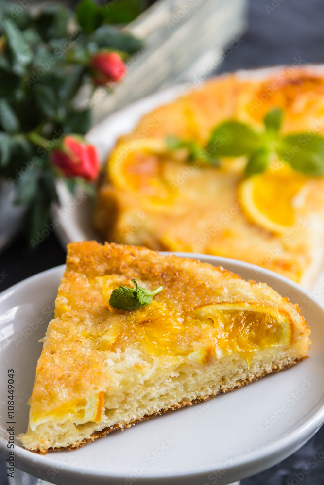 Orange cake, decorated with fresh mint (selective focus)